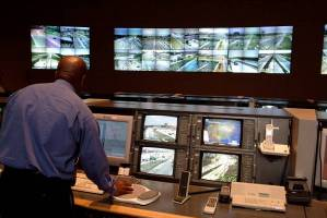 An operator standing in front of a console workstation in a TMC.